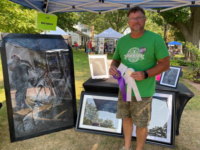 Matt Jagitsch appears with his award-winning works, a drawing of a gorilla that was selected best of show and a drawing for honorable mention during the 72nd Grand Detour Art Festival.
