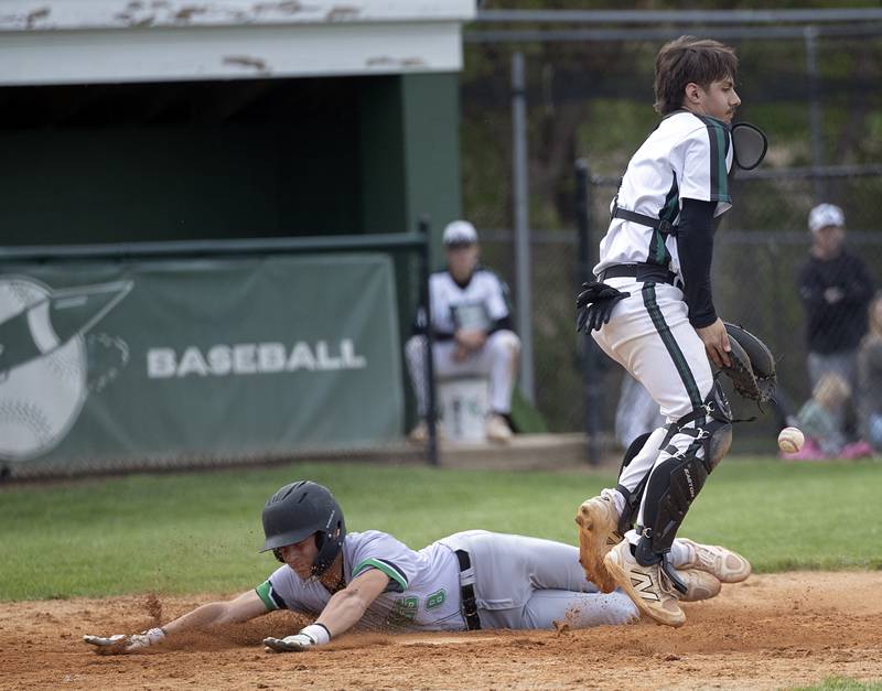 Rock Falls’ Alex Espinoza blocks s throw home on a fielder’s choice as North Boone’s Andrew Self comes in to score Tuesday, April 28, 2026.