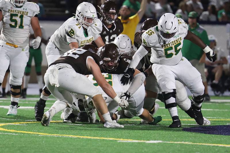 Joliet Catholic’s Michell Ragusa sacks Providence’s Colin Sheehan on Friday, Sept. 1, 2023 Joliet Memorial Stadium.