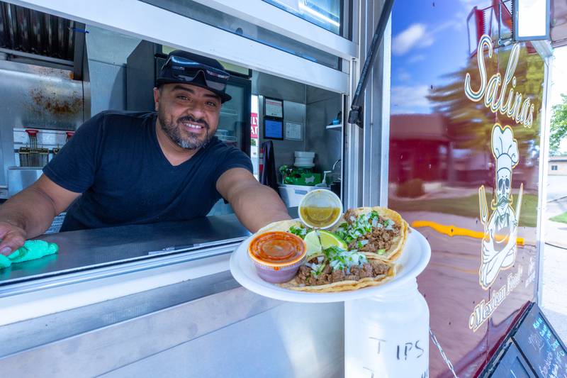 Raul Salinas holds Tacos on spatula from Salinas food truck on Monday, Aug 25, 2025 on Illinois Avenue in Mendota.