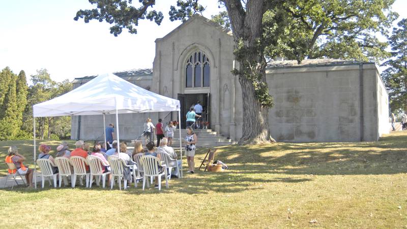A group listens to Karen Yardley speak about the Oakwood Cemetery mausoleum Sunday, Sept. 28, during the Lee County Historical and Genealogical Society's cemetery walk at Oakwood Cemetery in  Dixon.
