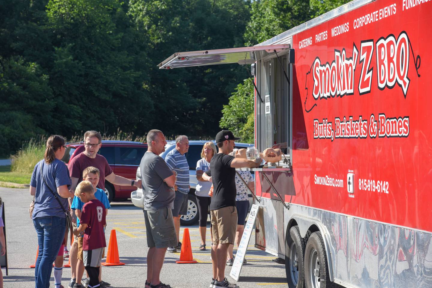 People line up at a food truck at a Forest Preserve District of Will County's Food Truck Friday in 2018 in Hammel Woods in Shorewood. Food truck events are a great way to introduce the community to the amenities the forest preserve offers.