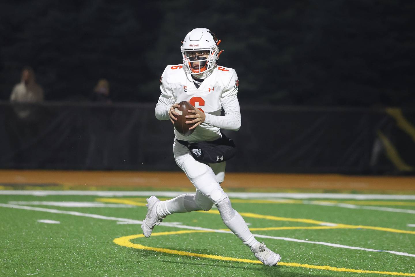 Plainfield East’s Brandon Parades rolls out to pass against Joliet West on Friday, Oct. 13, 2023 in Joliet.