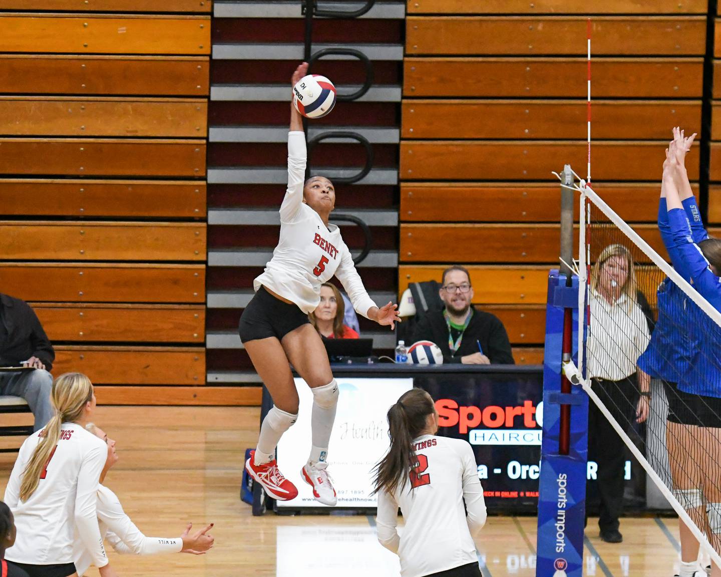 Benet Academy's Brooklynne Brass (5) spikes the ball while being defended by St. Charles North defenders during the first of two games on Thursday Nov. 7, 2024,  held at West Aurora during the 4A sectional championship match up.
