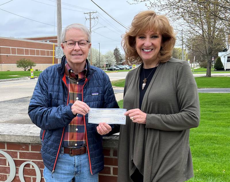 Mike Constance, DCCF board member, presents Laurie Wisdom, Open Door Program Coordinator, with a $12,000 check.