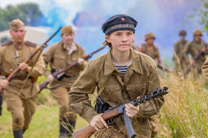 Soviet Military reenactor Avery-June McCabe charges up the battlefield towards the Germans during the simulated battle at the Ottawa Military Show on July 13, 2025 in rural Ottawa.