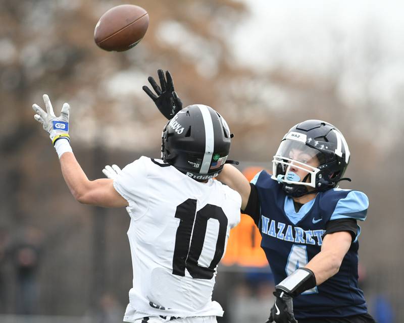 Fenwick's Will Tomczak (10) catches the ball while being defended y Nazareth Academy's Frankie Nichols (4) during the 6A semifinals game on Saturday Nov. 22, 2025, held at Nazareth Academy High School in La Grange Park.