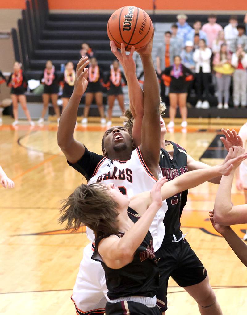 DeKalb's Chance Perry tries to grab a rebound between two Dunlap players during their game Monday, Nov. 21, 2022, at DeKalb High School.