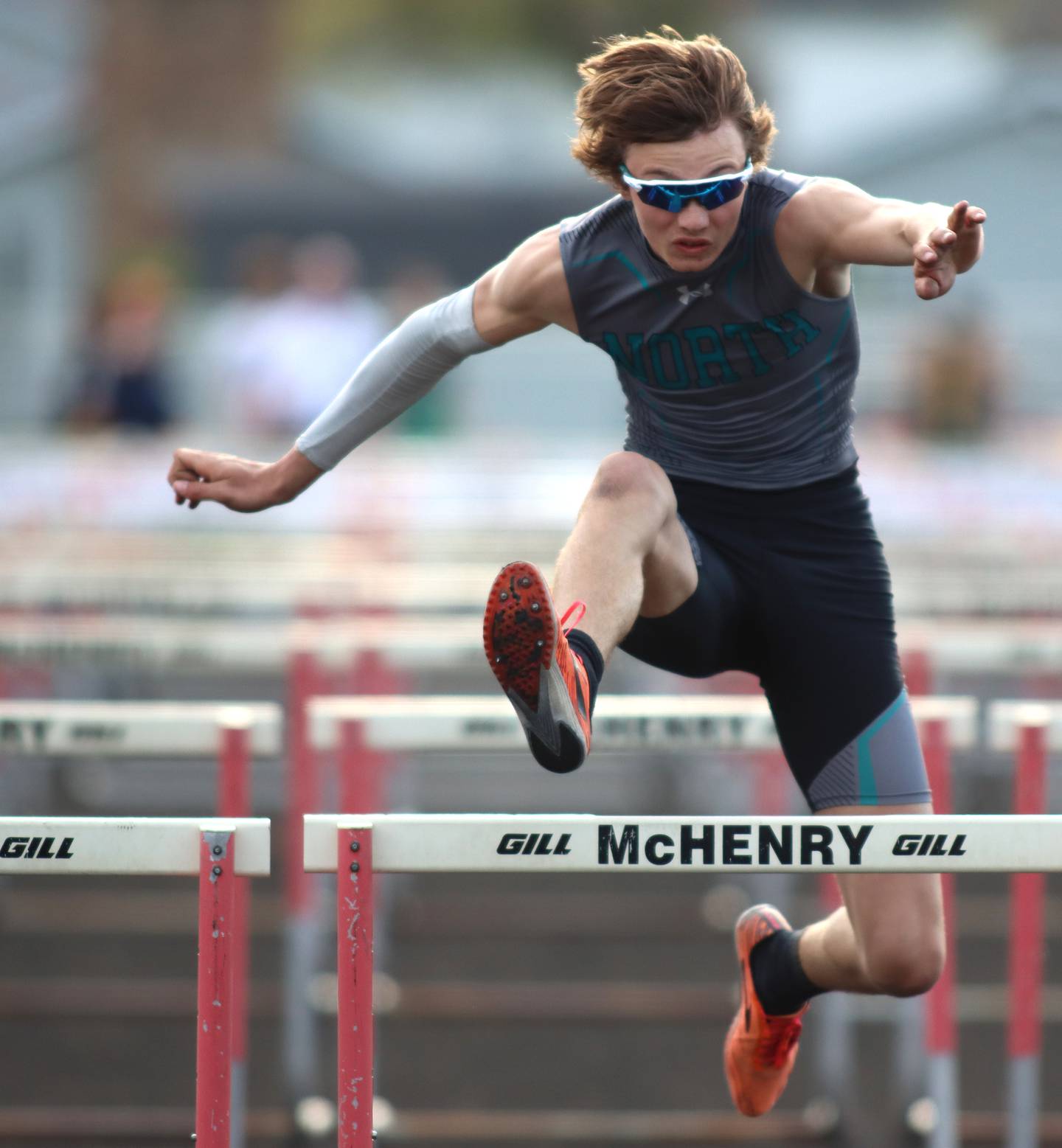 Woodstock North’s Braelan Creighton competes in the 110-meter hurdles during the McHenry County Track and Field Meet at McCracken Field on Thursday, April 24, 2025, in McHenry