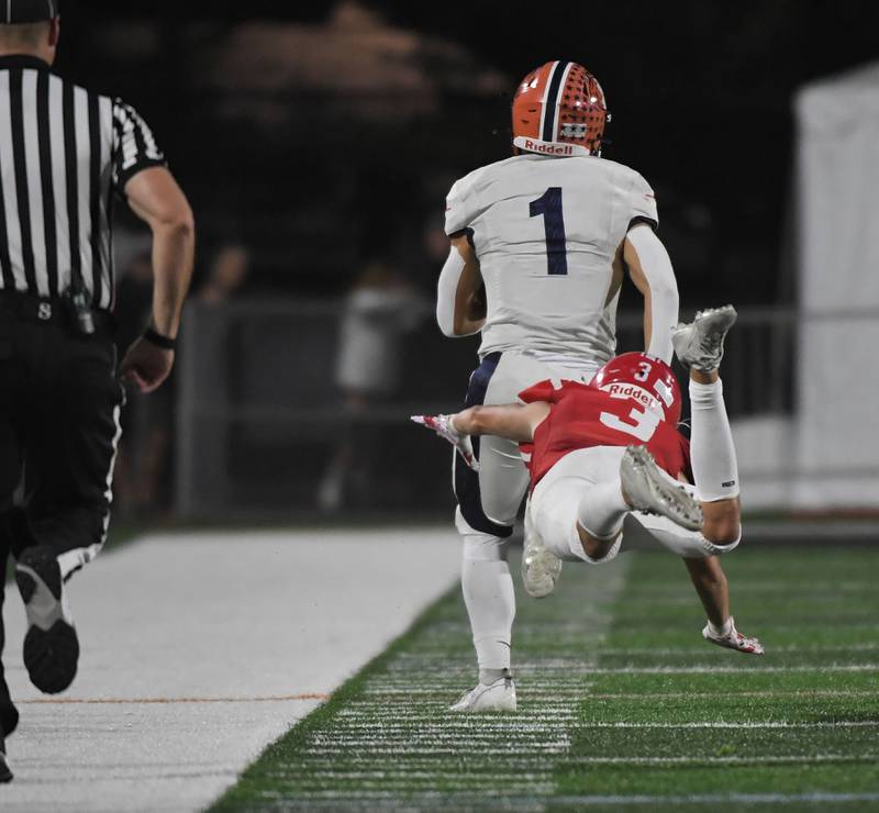 Naperville Central’s Aidan Sheehy dives but can’t reach Naperville North’s Cole Arl on a long touchdown run in a high school football game at North Central College in Naperville on Friday, September 29, 2023.