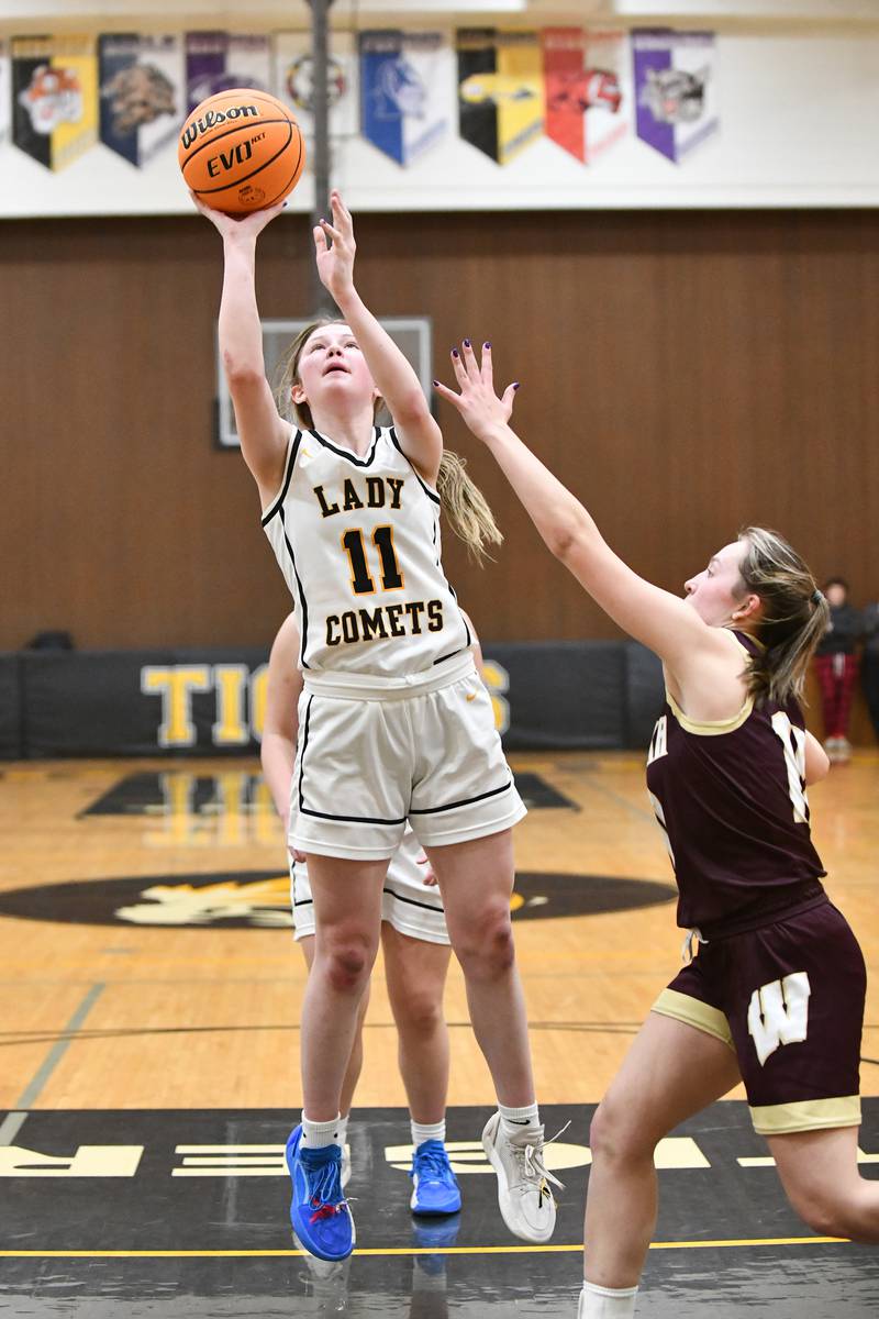 Reed-Custer's Morgan Toler shoots under pressure from Watseka's Christa Holohan during the Warriors' 50-24 victory over Reed-Custer in the IHSA Class 2A Herscher Sectional semifinal on Tuesday, Feb. 25.