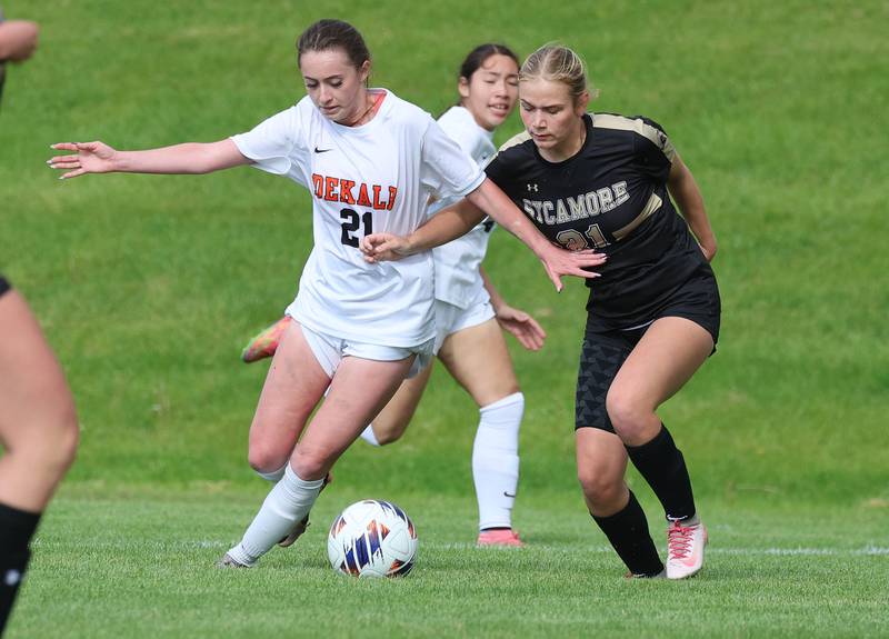 DeKalb's Quinn McLane and Sycamore's Kelsie Ryder fight for possession Thursday, May 7, 2026, during their game at Sycamore High School.