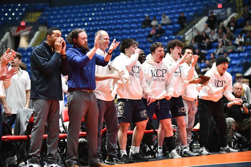 IC Catholic wrestlers celebrate Anthony Sebastian's 285-pound victory over Sean Thornton of Washington during the IHSA Dual Team State Finals in Bloomington on Saturday, March 1.