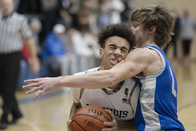 Newman’s Isiah Williams clashes against Princeton’s Teegan Davis Friday, Jan. 13, 2023.