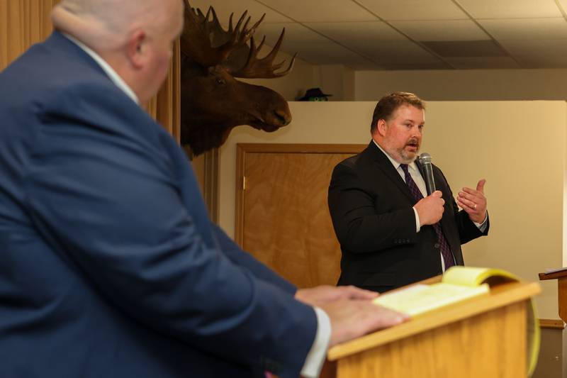 Bureau County States Attorney Candidate Dan Anderson speaks to crowd at debate whilst his opponent Brad Popurella watches on Wednesday, October 2, 2024 at Moose Lodge in Princeton.
