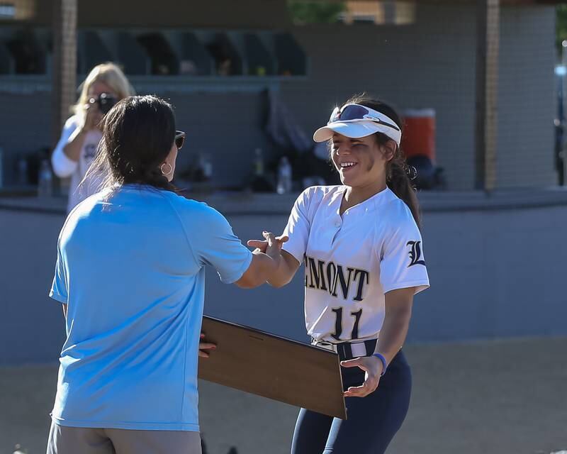 Lemont's Maya Hollendoner (11) is presented with the Class 3A Joliet Catholic Sectional final game plaque after defeating  Marian Catholic.  June 3, 2022.