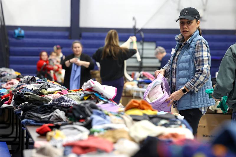 Volunteer Andrea Trivino helps organize supplies at Grace Christian Academy on Thursday, March 12, 2026, following the EF-3 tornado that tore through Kankakee County on March 10. The school, which is on the outskirts of Aroma Township along Waldron Road, canceled classes in order to become a supply and meal hub for those impacted by the storm.