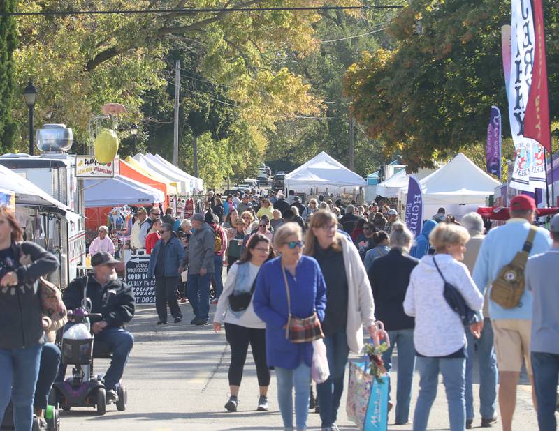 A crowd of people walk down Canal Street during the 54th annual Burgoo on Sunday, Oct. 13, 2024 downtown Utica.