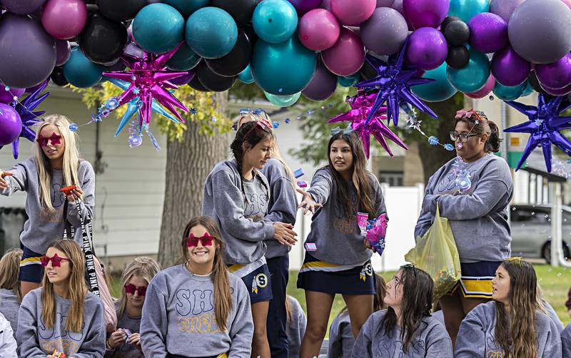 The Sterling High School cheer squad throws out candy and smiles Friday, Oct.6, 2023 during the homecoming parade.