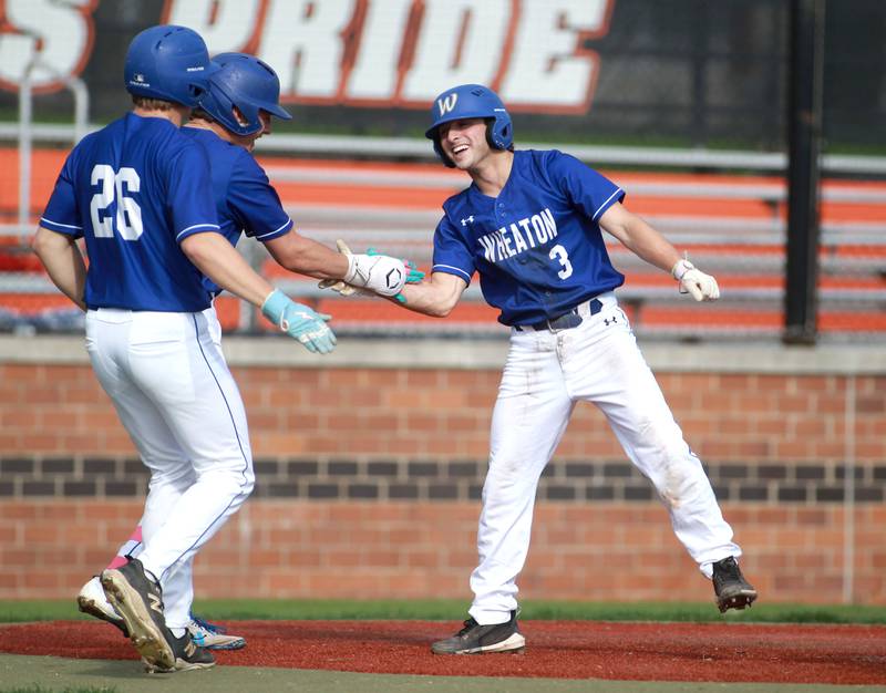 Wheaton North's Luke Bellini celebrates a run during a game against St. Charles East on Wednesday, April 23, 2025 in St. Charles.