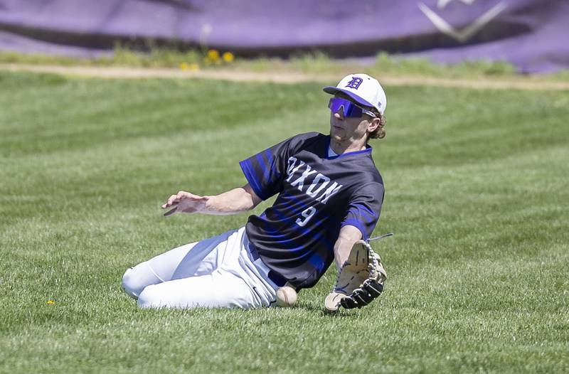 Dixon’s Collin Scott slides but comes up short on a hit for Newman Saturday, April 13, 2024 at Veterans Memorial Park in Dixon.