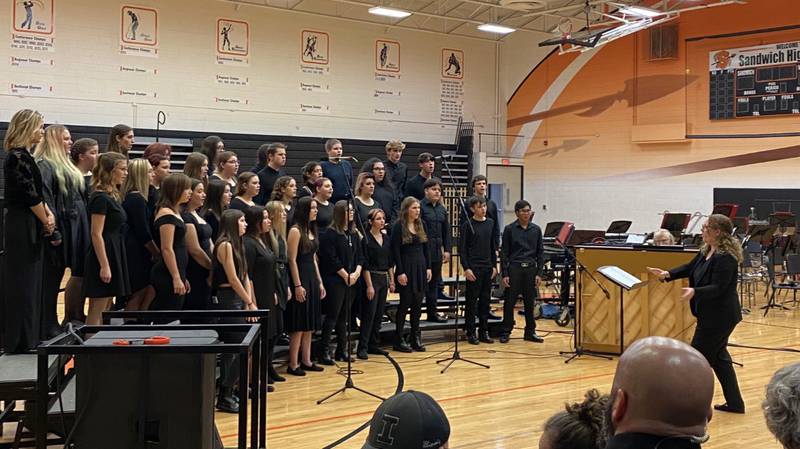 Taylor Marshall directing a concert choir performance on October 25, 2023 at Sandwich High School.