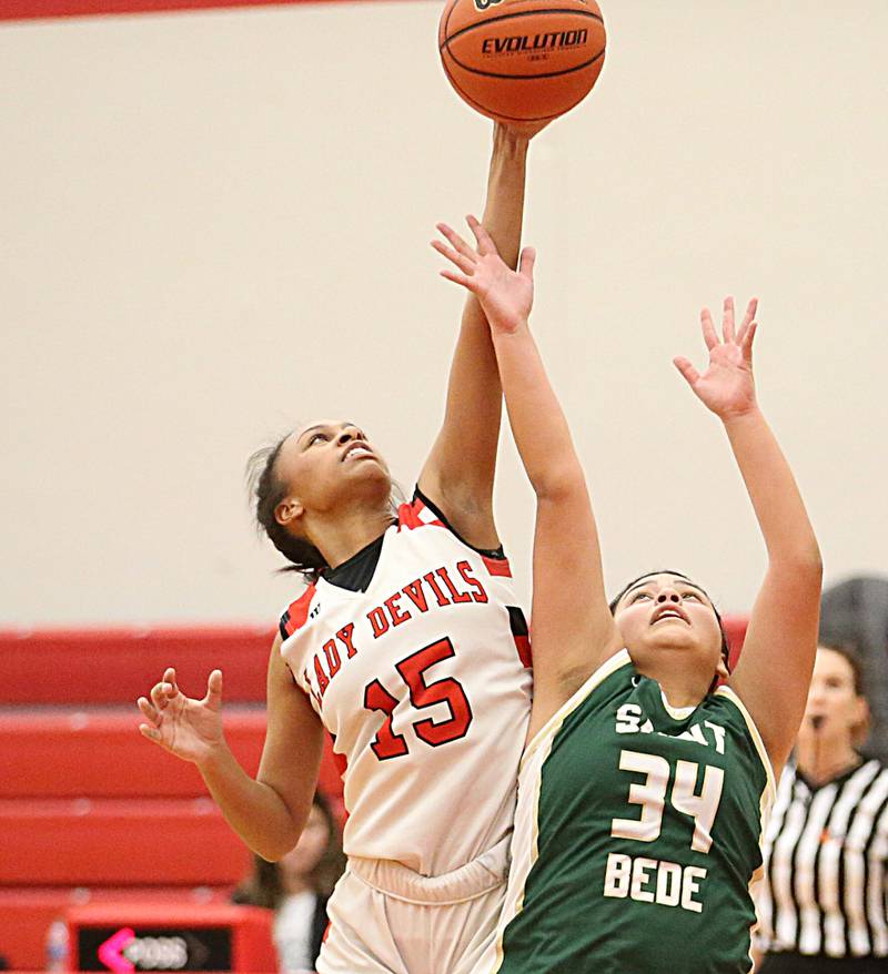Hall's Jayden Jones (15) leaps in the air to grab a rebound over St. Bede's Brianna Torres on Monday, Nov. 28, 2022 at Hall High School in Spring Valley.