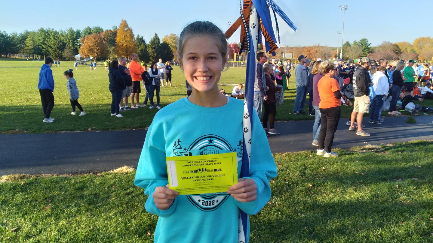 Princeton senior Lexi Bohms holds the all important parking pass for Saturday's IHSA State Cross Country Meet in Peoria. She punched a return ticket by finishing as the 10th and final individual qualifier from the Oregon Sectional.