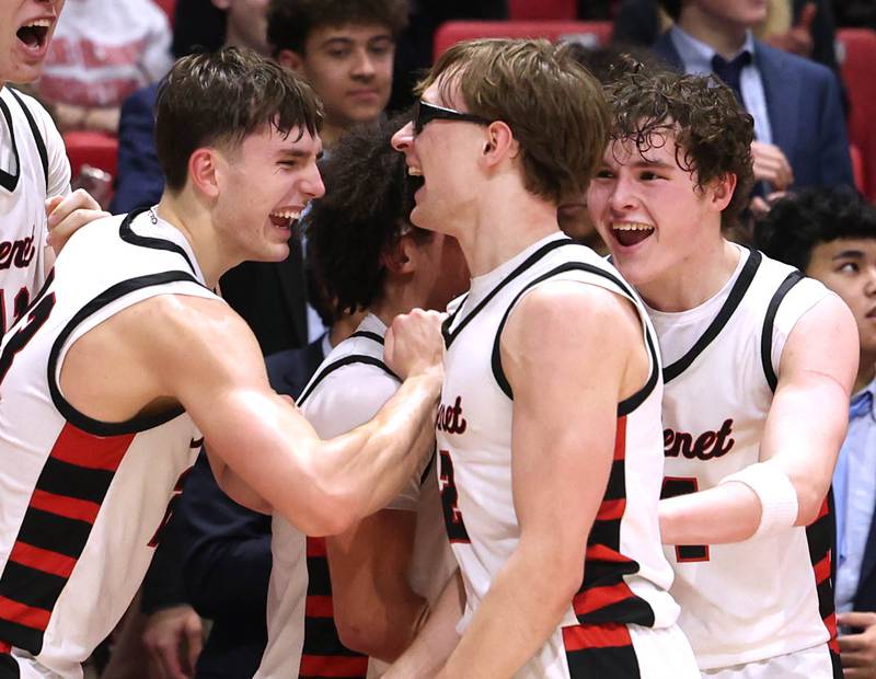 Benet players celebrate after their win Monday, March 9, 2026, in their IHSA Class 4A supersectional win over Auburn in the Convocation Center at Northern Illinois University in DeKalb.