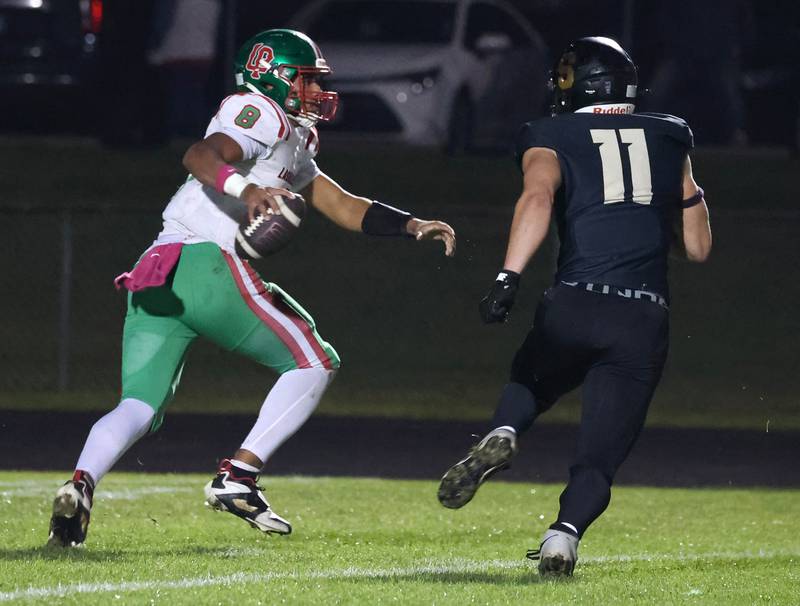 Sycamore's Vincent Pitstick flushes La Salle-Peru quarterback Marion Persich out of the pocket during their game Friday, Oct. 10, 2025, at Sycamore High School.