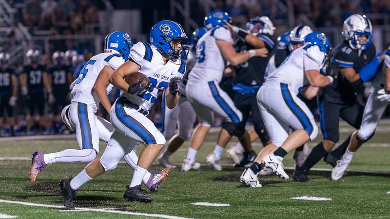 Lake Zurich's Chris Pirrone (23) carries the ball against St. Charles North during a football game at St. Charles North High School on Friday, Sep 2, 2022.