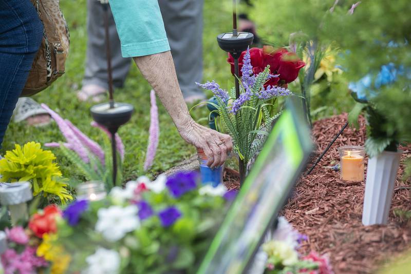 Flowers and candles were placed at the site of the fire. Wednesday marked the second year anniversary of the arson case that killed three people in Sterling.