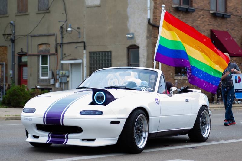 Paraders driving a Mazda Miata “Winks” its headlights on Saturday, June 8, 2024 at Jordan Block Park in Ottawa.
