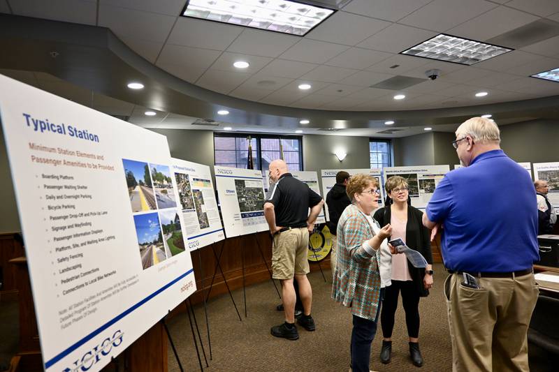 Attendees gather around the displays at Wednesday’s open house, one of four planned by the North Central Illinois Council of Governments (NCICG) that were held in the communities with the proposed stops.