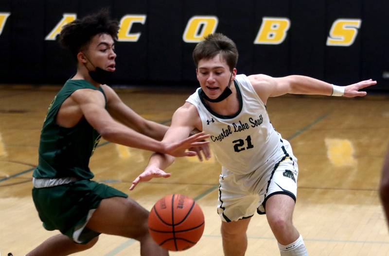 Waubonsie Valley’s Braylon Spicer, left, battles Crystal Lake South’s Cooper LePage for the ball during Hinkle Holiday Classic Tournament action at H.D. Jacobs High School in Algonquin on Saturday.