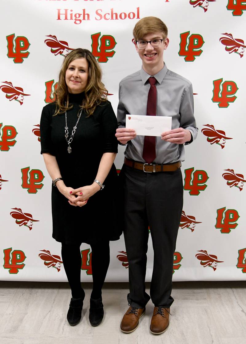 Jacob Quick (right) received the R. Earl Trobaugh Presidential Scholarship, presented by La Salle-Peru High School English Division Chair Michele Honecker-Ummel (left).