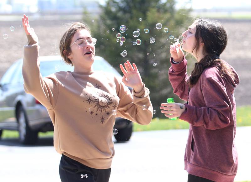 Wallace student Lillian Clayton runs through bubbles while her classmate Lylah Dumke blows them toward her face during the "Warrior Games" on Friday, May 5, 2023 at Wallace Grade School. The unified event promoted inclusiveness, friendships and fun. Local area schools from La Salle, Peru, Ottawa, Earlville and others participated in the event.