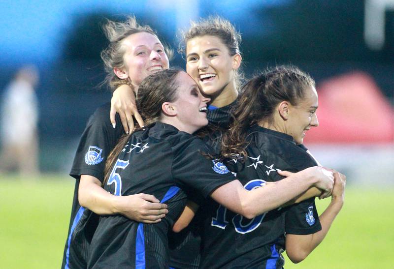 St. Charles North players (left to right) Kaitlin Glenn, Rian Spaulding, Kayla Floyd and Laney Stark celebrate their win over St. Charles East in a Class 3A South Elgin Sectional semifinal game on Tuesday, May 21, 2024.