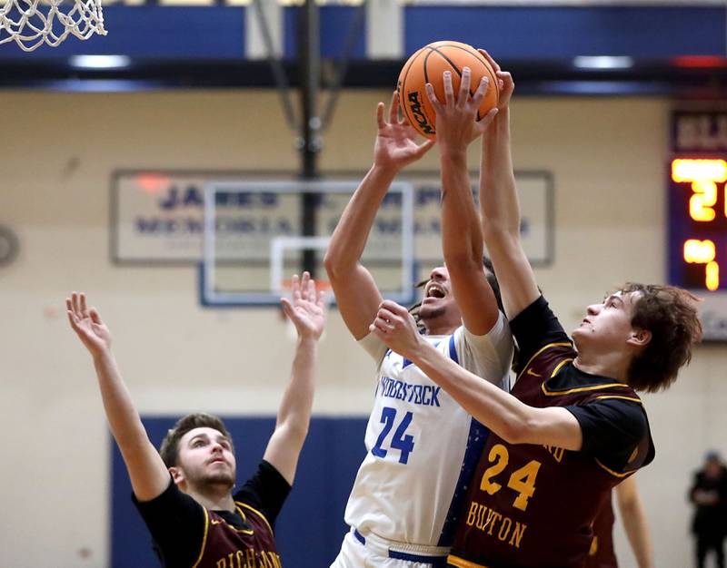 Woodstock's JJ Stokes has his shot blocked by Richmond-Burton's Landon Nelson during a Kishwaukee River Conference boys basketball game on Wednesday, February. 4, 2026, at Woodstock High School.