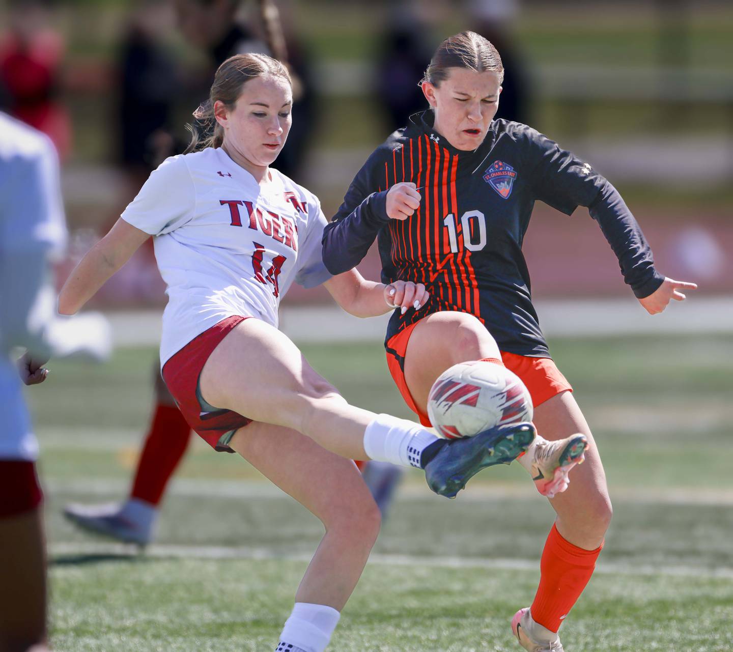St. Charles East’s Qori Strotkamp, (10) battles Plainfield North’s Hailey Johnson, (14) Saturday, March 28, 2026 during the Championship game of the St. Charles East girls soccer invitational.