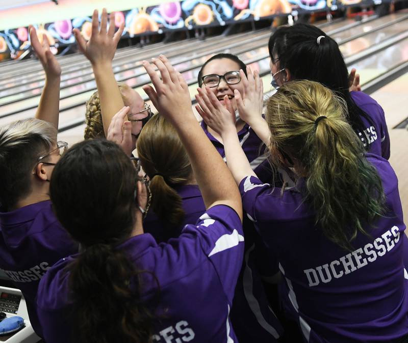 Dixon's Tianna Bryson celebrates her 287 game with her teammates at the IHSA bowling regional in DeKalb on Saturday.