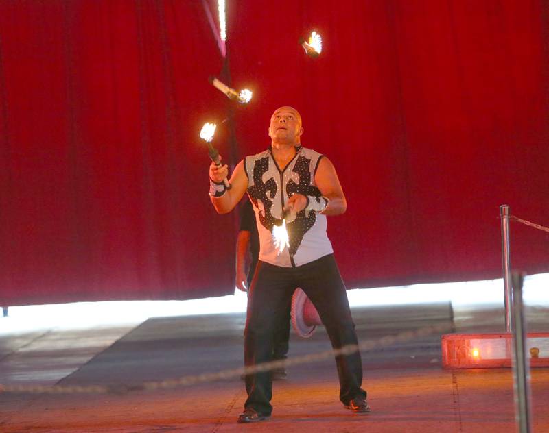 The Great Pages Circus performer juggles fire on Monday, June 23, 2025 at the Bureau County Fairgrounds in Princeton. The Great Pages Circus is a family-friendly, traveling circus that blends traditional circus acts with a modern, energetic style.