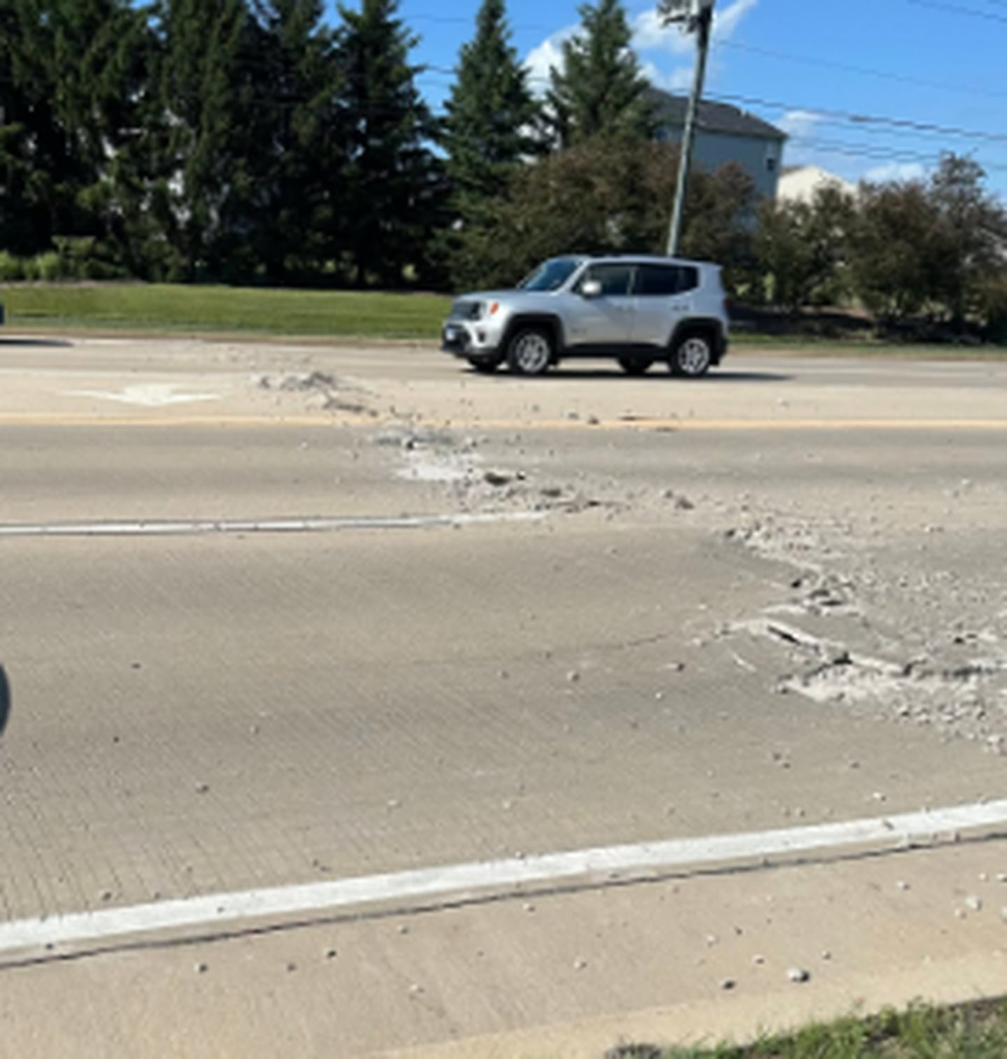 Debris was strewn across the roadway after Route 34 buckled and cracked from excess heat and moisture in Plano.