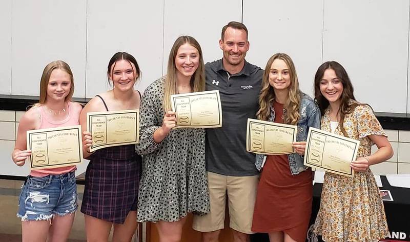 Woodland/Flanagan-Cornell softball coach Jordan Farris stands with his Tri-County All-Conference players from this past season, (left to right) Olivia Chismarick, Cheyenne Burns, Ella Sibert, Cloee Johnston and Shae Simons.