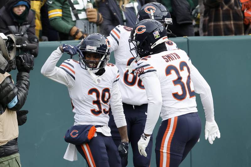 Chicago Bears' Josh Blackwell (39) celebrates after scoring on a punt return with Terell Smith (32) and Collin Johnson during the first half of an NFL football game against the Green Bay Packers, Sunday, Jan. 5, 2025, in Green Bay, Wis. (AP Photo/Mike Roemer)