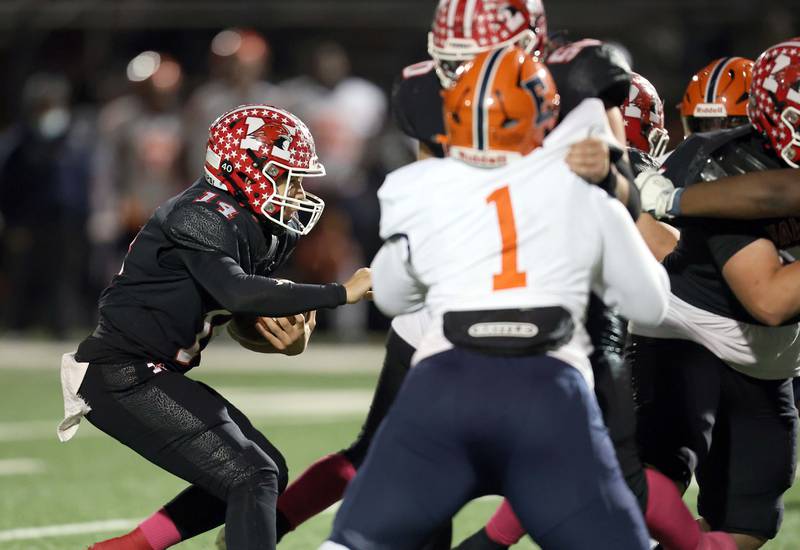 Maine South's Constantine Coines (14) looks for some running room Friday October 20, 2023 in Park Ridge.
