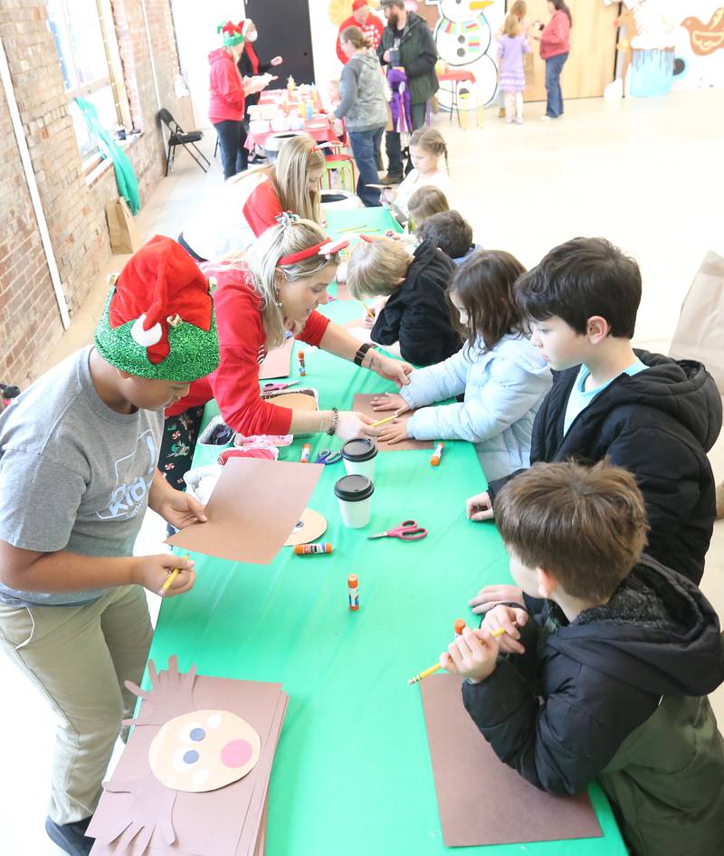 Children make crafts at Ax Church during the Miracle on First Street event on Saturday, Dec. 2, 2023 in La Salle.
