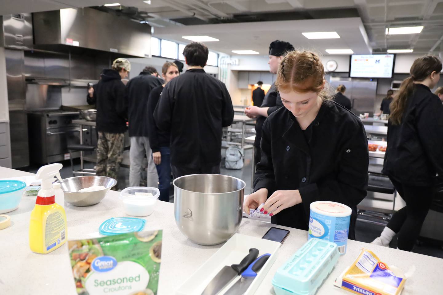 Anastazja Wygrzyn, 17, helps to prep the meal McHenry High School's Warrior Chef class planned for Thursday, Feb. 8, 2024. The 40-person meal was the first large catering order for the students.