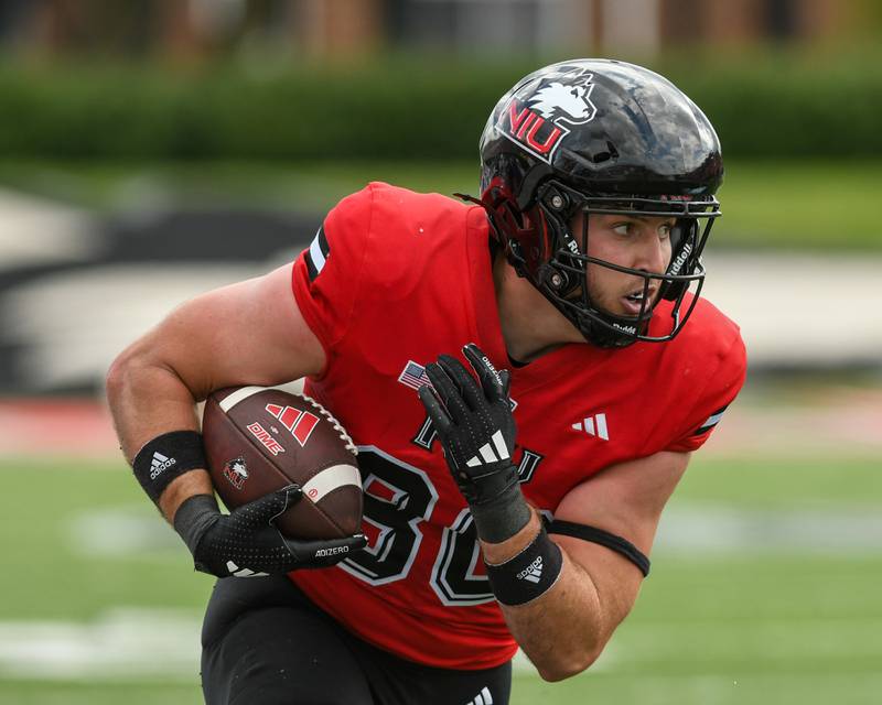Northern Illinois University's tight end Jake Appleget (80) gains a few yards after catching a pass by quarterback Josh Holst (15) during the game on Saturday Aug. 30, 2025, while taking on Holy Cross held at Huskie Stadium in DeKalb.