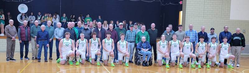 Over two dozen former Seneca boys basketball players — those who played at one time or another when the gym was the Fighting Irish's home from 1950-1980 — pose with the current team during 'throwback night' at the West Campus Gymnasium on January 5.